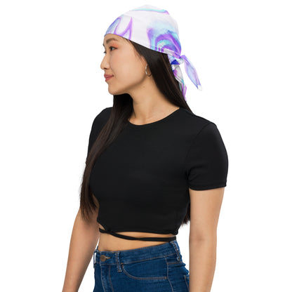 Woman wearing a black crop top and blue jeans with a colorful headscarf on a white background