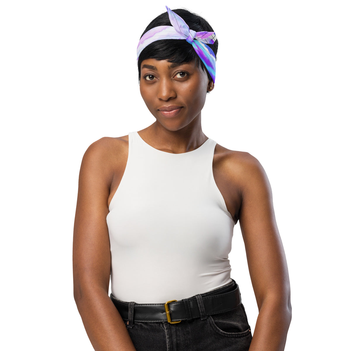 Woman wearing a white tank top and black pants with a colorful headband on a white background