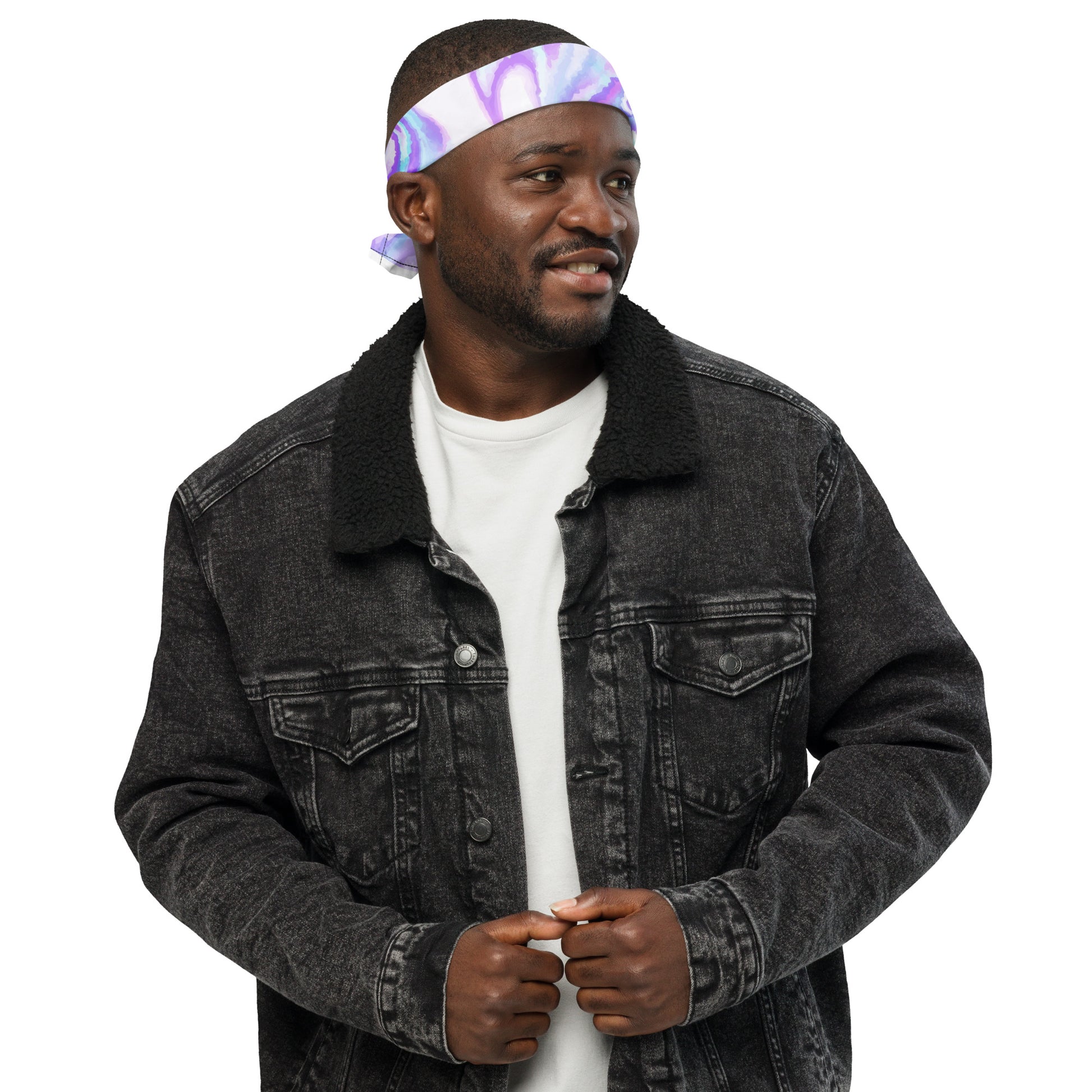 Man wearing a black denim jacket and white shirt with a colorful headband on a white background