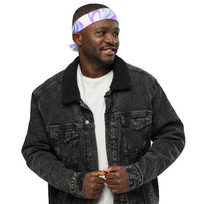 Man wearing a black denim jacket and white shirt with a colorful headband on a white background