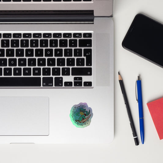 Laptop with smartphone, pen, and sticky notes on a white surface